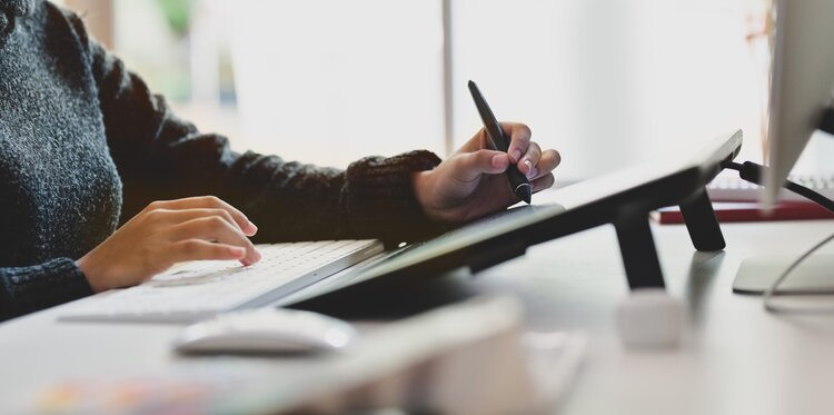 Worker typing and using a stylus