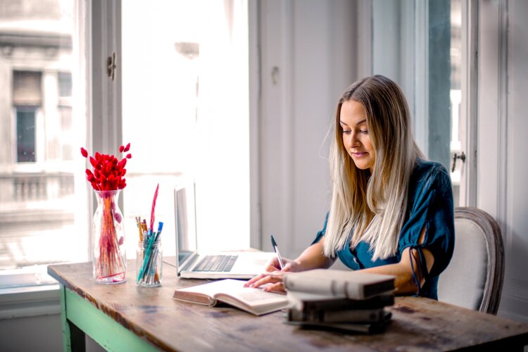 Woman writing with ball point pen