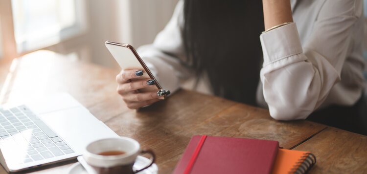 Woman with manicured nails using cell phone 