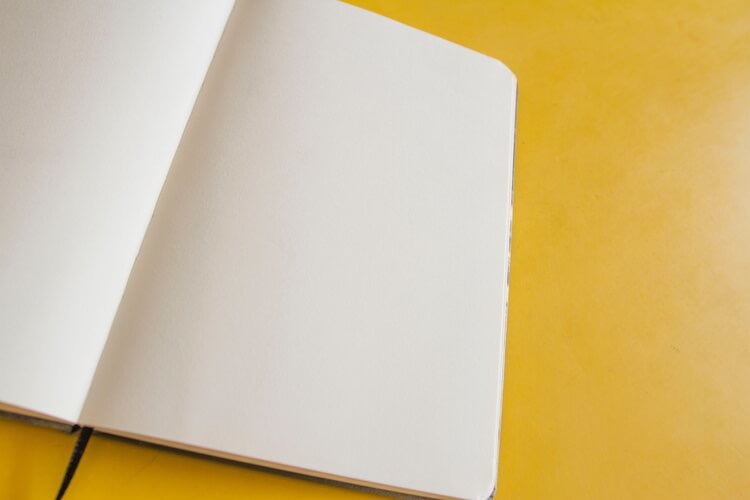 Yellow background, book with blank page